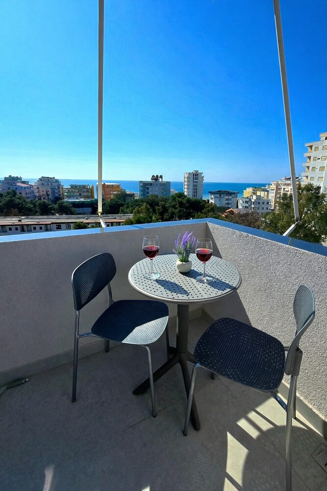Private balcony with table, chairs, and sea view