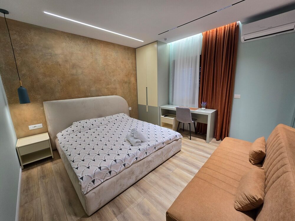 Bedroom with bed and warm curtain accents