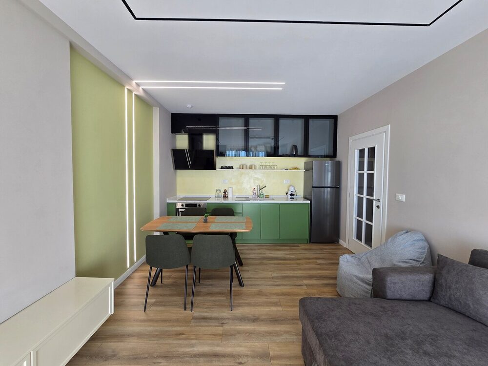 Open kitchen with dining table and sofa