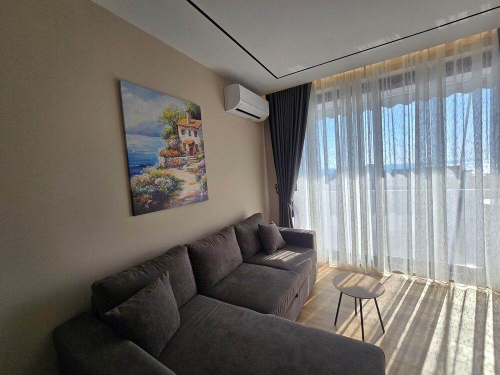 Sunlit living room with grey sofa
