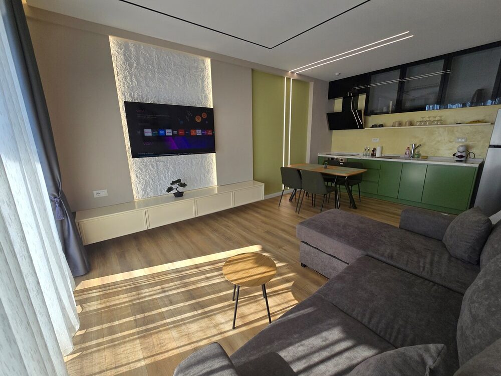Living room with mounted TV and dining table