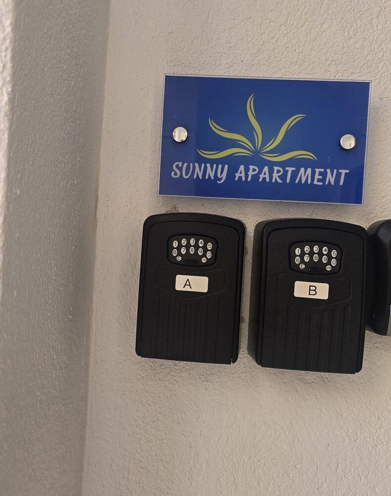 Sunny Apartment building entrance with two door buzzers, A and B