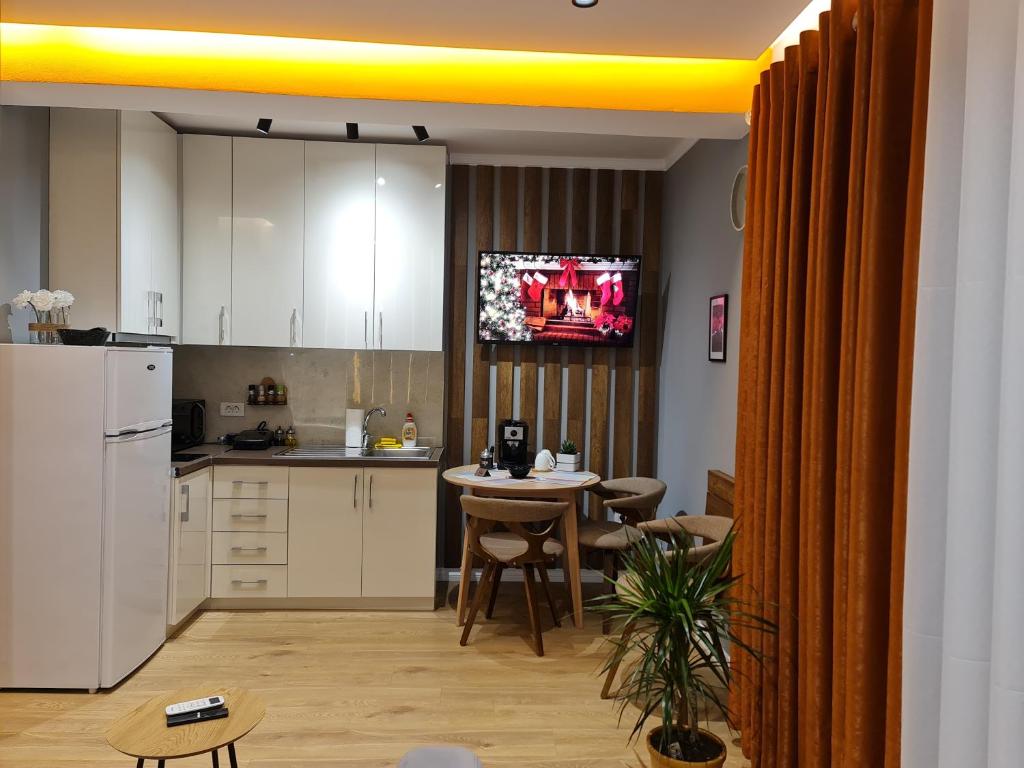Kitchen and dining nook with espresso machine and TV