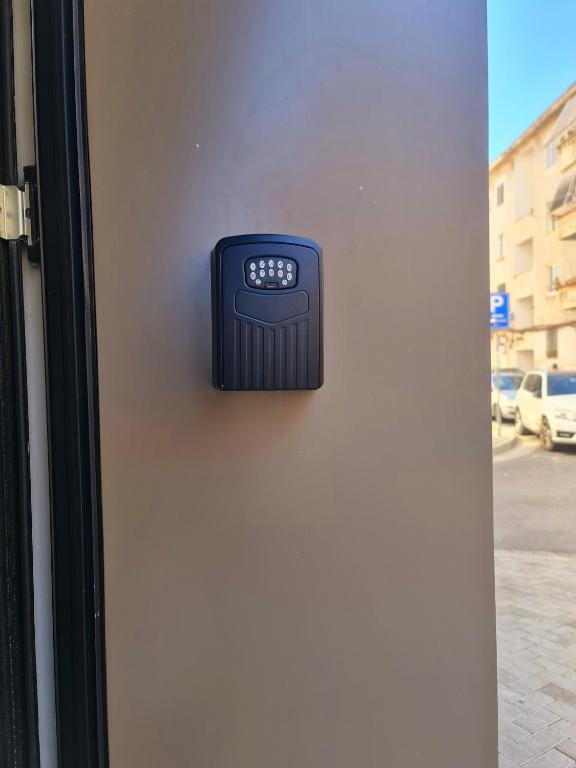 Keypad lockbox by the entrance with Blloku street in the background