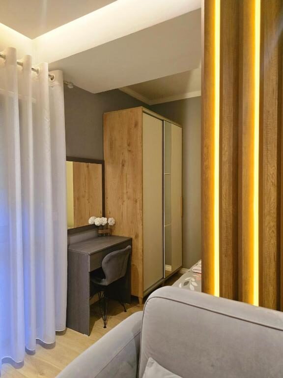 Wardrobe corner behind a sheer curtain divider