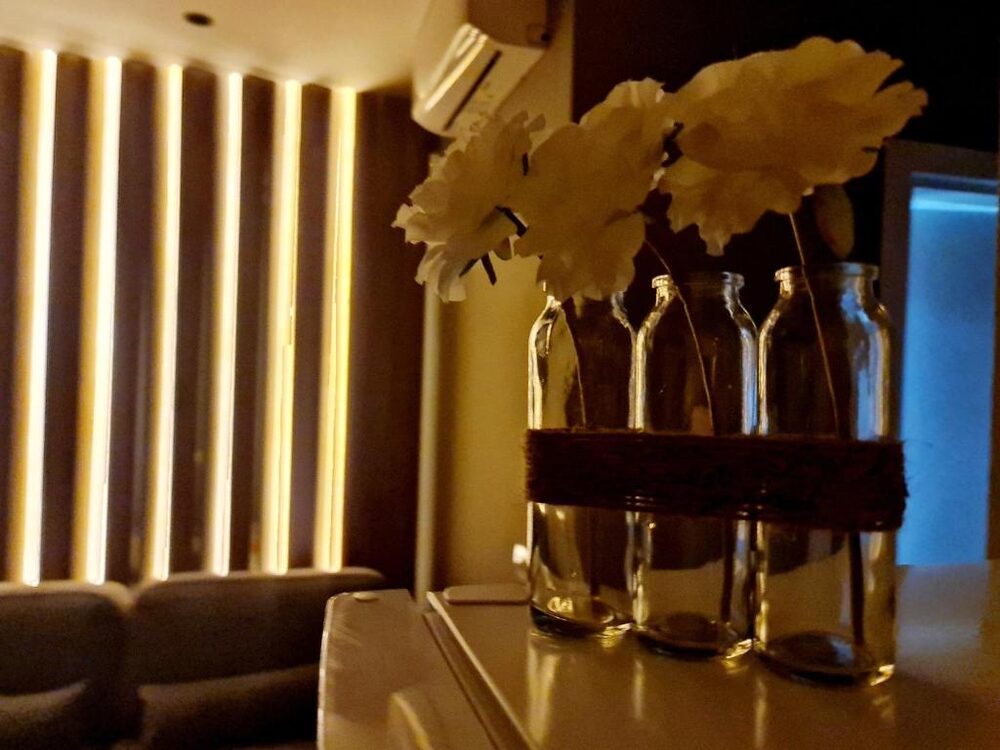 Decorative accent nook with a backlit wall and vases