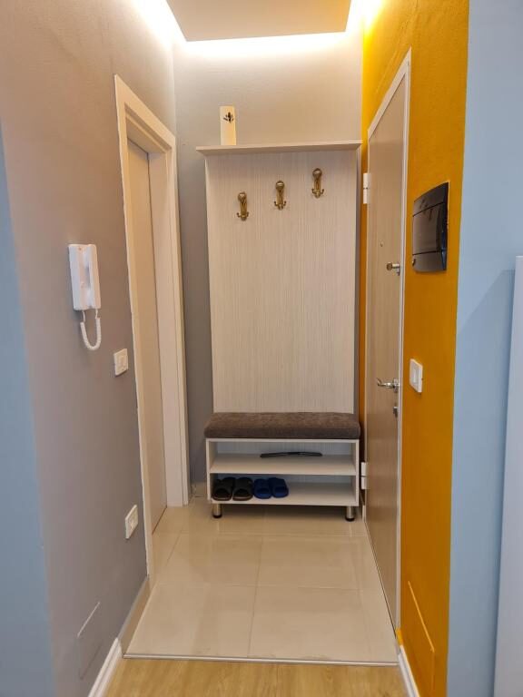 Entryway with coat hooks and a shoe bench