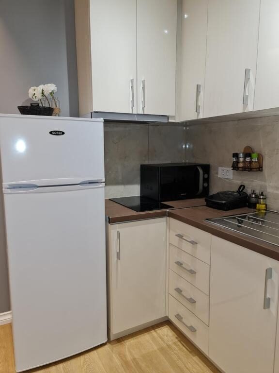 Kitchen counter with refrigerator and microwave