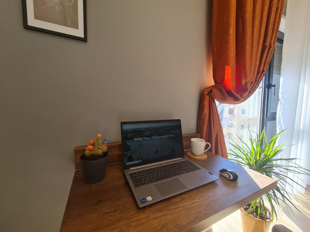 Desk with laptop by the window, set up for remote work